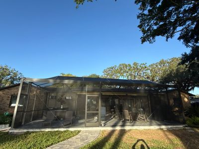 Wide exterior view of completed screen enclosure by Drome Contracting