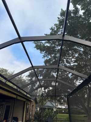 Interior of completed screen enclosure with lounge seating by Drome Contracting